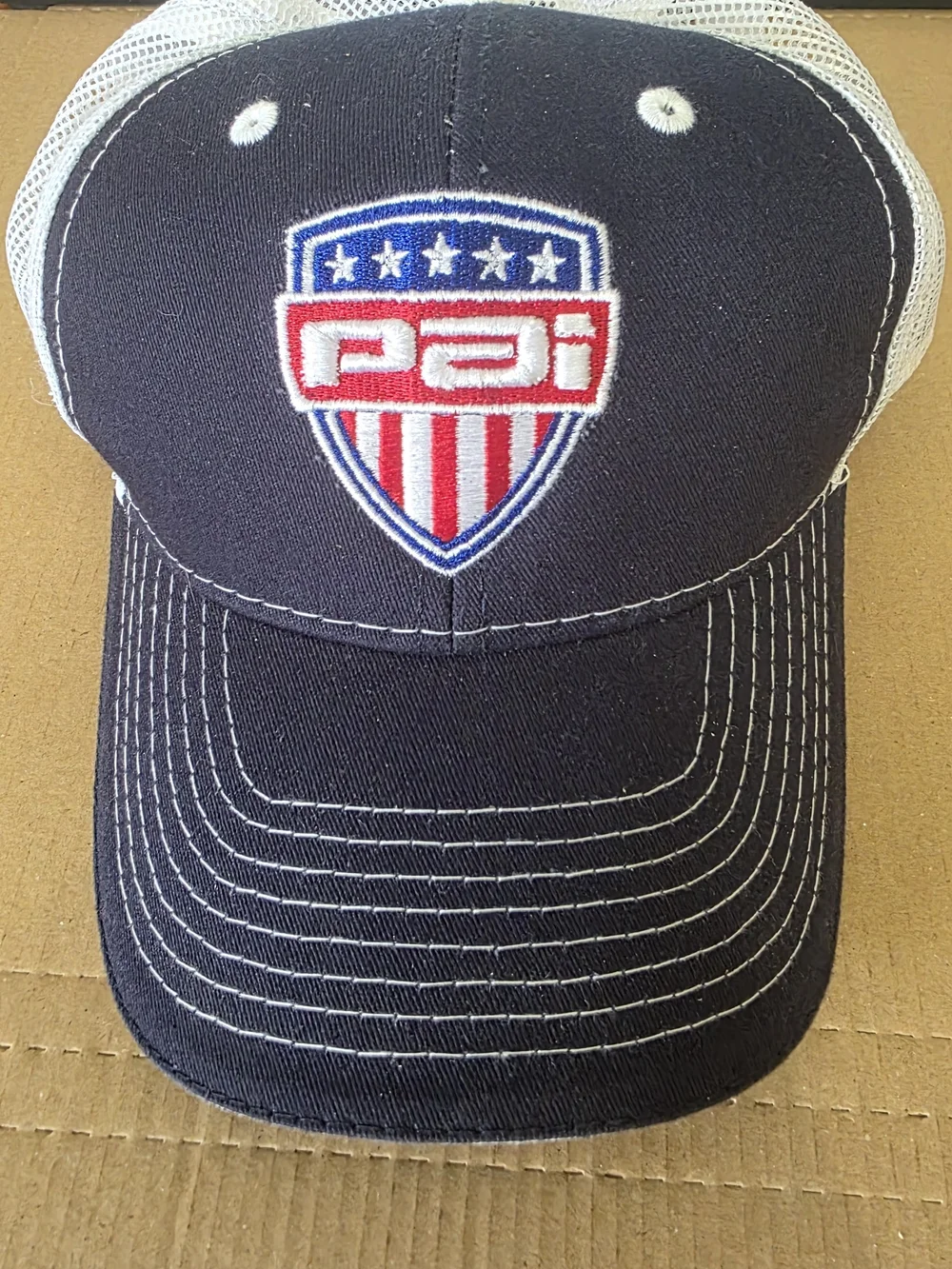 PAI Shield Trucker Hat - Navy with Red, White & Blue Patch